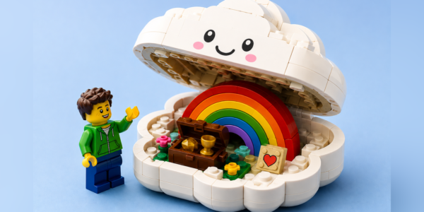 A smiling white brick-built cloud opens to reveal a colorful rainbow, treasure chest and small heart tile, with a generic brick figure standing beside it.