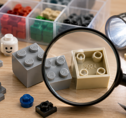 Editorial macro scene showing used brick elements being inspected under a magnifying glass, with molded LEGO marks on studs and the number 3024 visible inside a part.