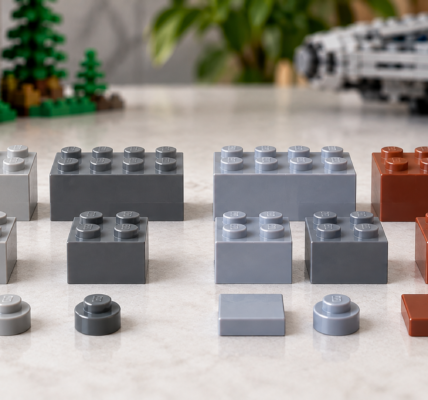 A side-by-side comparison of older and newer gray and brown brick colors arranged on a light tabletop.