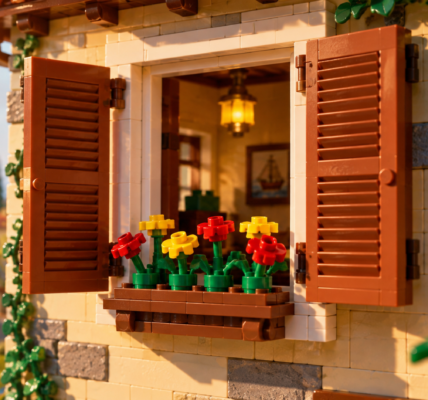 Widely open classic brown slatted shutters frame a window with red and yellow flowers in a planter on a warm nostalgic brick-built facade.